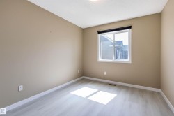 Spare room with light wood-type flooring and a textured ceiling - 