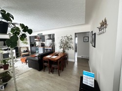 Dining room featuring wood finished floors and a textured ceiling - 
