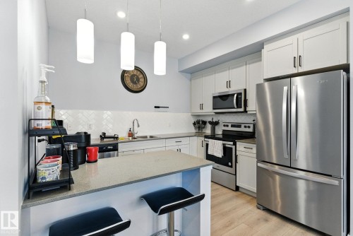 105 1304 Rutherford Rd, Edmonton, AB - Indoor Photo Showing Kitchen With Stainless Steel Kitchen With Double Sink With Upgraded Kitchen