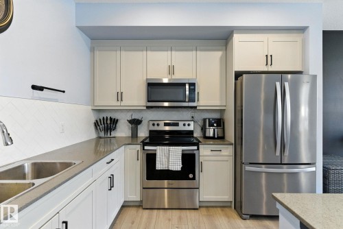 105 1304 Rutherford Rd, Edmonton, AB - Indoor Photo Showing Kitchen With Stainless Steel Kitchen