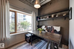 Dining space with wood finished floors and concrete block wall - 