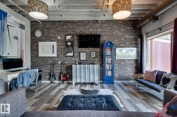 Living area with brick wall and wood finished floors - 
