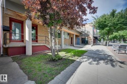 Exterior space with brick siding, a porch, and stairway - 