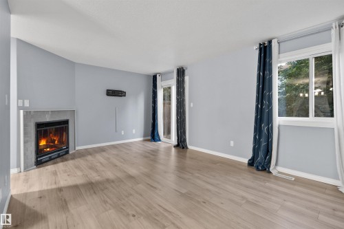 5 14803 34 St, Edmonton, AB - Indoor Photo Showing Living Room With Fireplace