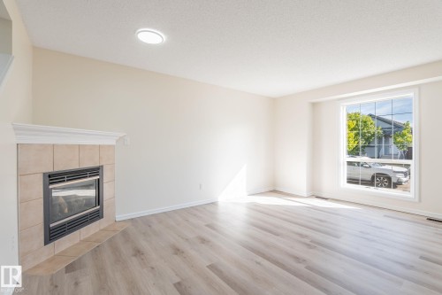 2912 31 Street, Edmonton, AB - Indoor Photo Showing Living Room With Fireplace