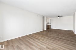 Unfurnished living room featuring light wood-type flooring, ceiling fan, and a textured ceiling - 