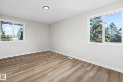 Spare room featuring light wood-type flooring and baseboards - 