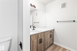 Bathroom featuring light wood-type flooring and vanity - 