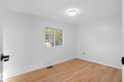 Empty room featuring light wood-style floors and baseboards - 