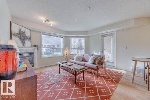102 9008 99 Avenue, Edmonton, AB - Indoor Photo Showing Living Room With Fireplace