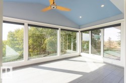 Unfurnished sunroom with vaulted ceiling and recessed lighting - 