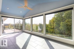 Unfurnished sunroom with lofted ceiling, recessed lighting, and tile patterned flooring - 