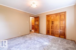 Unfurnished bedroom with crown molding, a closet, and carpet flooring - 