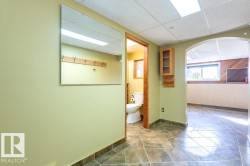 Half bathroom featuring a paneled ceiling and tile patterned floors - 