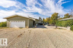 View of front facade with driveway, a wooden deck, and a garage - 
