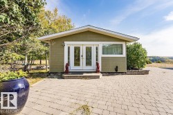 Back of house with french doors, a patio area, and an outdoor structure - 