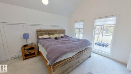 Bedroom featuring light carpet, a decorative wall, and high vaulted ceiling - 11308 128 Street, Edmonton, AB - Indoor Photo Showing Bedroom
