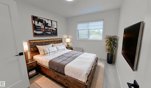 Bedroom with radiator heating unit and baseboards - 11308 128 Street, Edmonton, AB - Indoor Photo Showing Bedroom