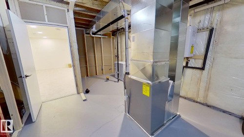 Utility room with heating unit and tankless water heater - 11308 128 Street, Edmonton, AB - Indoor Photo Showing Basement