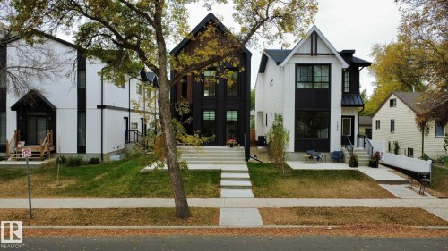 View of front of home featuring entry steps, a standing seam roof, a metal roof, and a front lawn - 11308 128 Street, Edmonton, AB - Outdoor With Facade