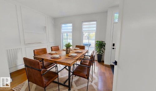 Dining space with a decorative wall and wood finished floors - 11308 128 Street, Edmonton, AB - Indoor Photo Showing Dining Room