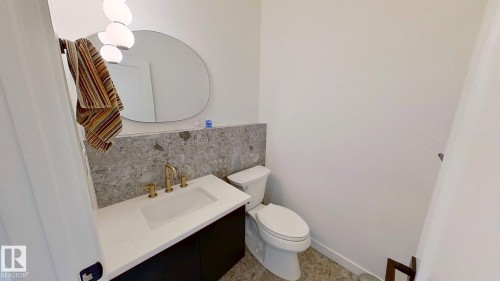 Half bath featuring vanity and backsplash - 11308 128 Street, Edmonton, AB - Indoor Photo Showing Bathroom