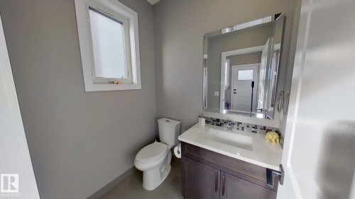 Bathroom featuring healthy amount of natural light, vanity, and backsplash - 8809 148 Street, Edmonton, AB - Indoor Photo Showing Bathroom