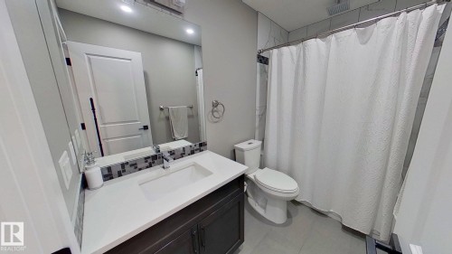 Bathroom featuring vanity and a shower with curtain - 8809 148 Street, Edmonton, AB - Indoor Photo Showing Bathroom