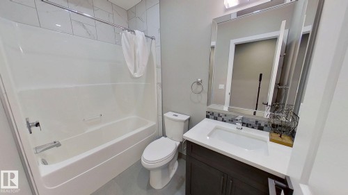 Bathroom with shower / tub combo with curtain, vanity, tasteful backsplash, and tile patterned floors - 8809 148 Street, Edmonton, AB - Indoor Photo Showing Bathroom