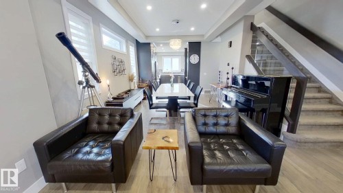 Living area with stairway, wood finished floors, a raised ceiling, and recessed lighting - 8809 148 Street, Edmonton, AB - Indoor Photo Showing Other Room