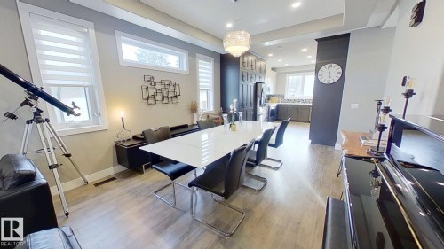 Dining area with light wood-type flooring, recessed lighting, and a tray ceiling - 8809 148 Street, Edmonton, AB - Indoor