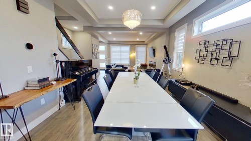 Dining area with plenty of natural light, light wood-style floors, a tray ceiling, and recessed lighting - 8809 148 Street, Edmonton, AB - Indoor Photo Showing Other Room