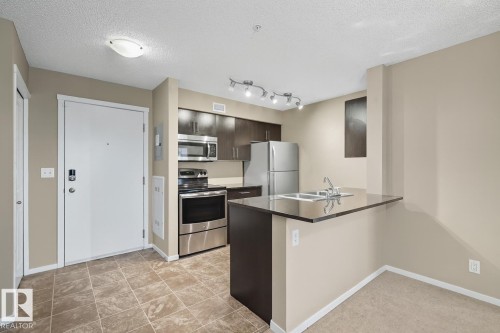 205 5810 Mullen Place, Edmonton, AB - Indoor Photo Showing Kitchen With Double Sink