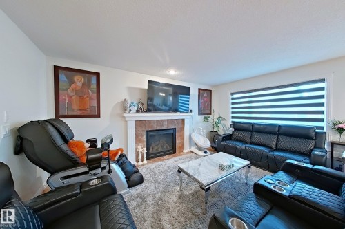 3008 24 Avenue, Edmonton, AB - Indoor Photo Showing Living Room With Fireplace