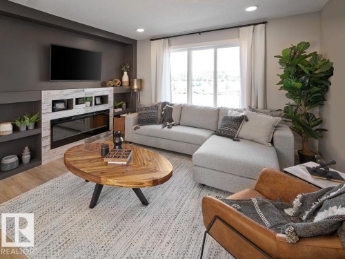 84 1025 Secord Promenade, Edmonton, AB - Indoor Photo Showing Living Room With Fireplace