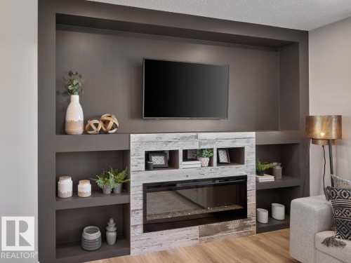 84 1025 Secord Promenade, Edmonton, AB - Indoor Photo Showing Living Room With Fireplace