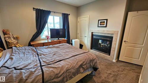 36 3003 34 Avenue, Edmonton, AB - Indoor Photo Showing Bedroom With Fireplace
