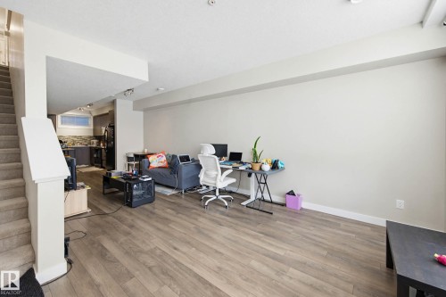 Office area with light wood-style flooring and track lighting - 90 2560 Pegasus Boulevard, Edmonton, AB - Indoor Photo Showing Other Room