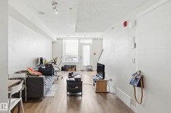 Living room featuring a textured ceiling and hardwood / wood-style floors - 