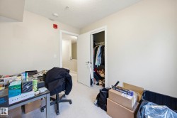 Office featuring light colored carpet and a textured ceiling - 