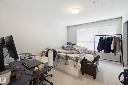 Carpeted bedroom featuring an office area and a textured ceiling - 90 2560 Pegasus Boulevard, Edmonton, AB - Indoor