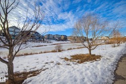 Yard covered in snow featuring a residential view - 