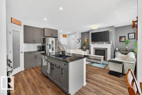 17096 46 Street, Edmonton, AB - Indoor Photo Showing Kitchen With Fireplace With Stainless Steel Kitchen With Double Sink With Upgraded Kitchen