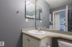 Bathroom with vanity, a textured ceiling, and washer / clothes dryer - 