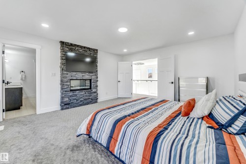 3104 61 Avenue, Rural Leduc County, AB - Indoor Photo Showing Bedroom With Fireplace