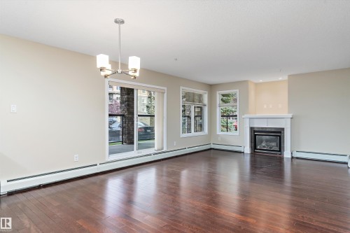 132 11603 Ellerslie Road, Edmonton, AB - Indoor Photo Showing Living Room With Fireplace