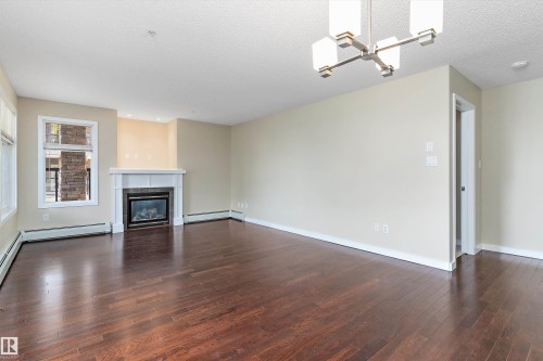 132 11603 Ellerslie Road, Edmonton, AB - Indoor Photo Showing Living Room With Fireplace