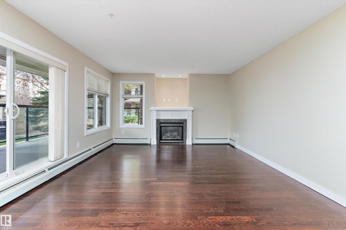 132 11603 Ellerslie Road, Edmonton, AB - Indoor Photo Showing Living Room With Fireplace