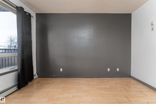 Spare room featuring light wood-style floors and a textured ceiling - 101 6220 134 Avenue, Edmonton, AB - Indoor Photo Showing Other Room