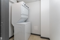 Washroom with stacked washer / dryer and baseboards - 